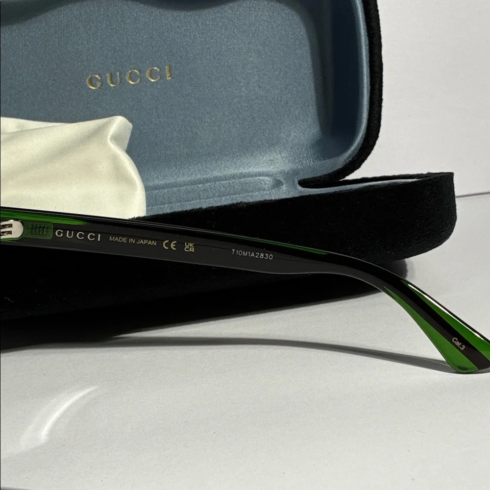 New Authentic GG0057SKN 002 Gucci Black Sunglasses with Green Lenses